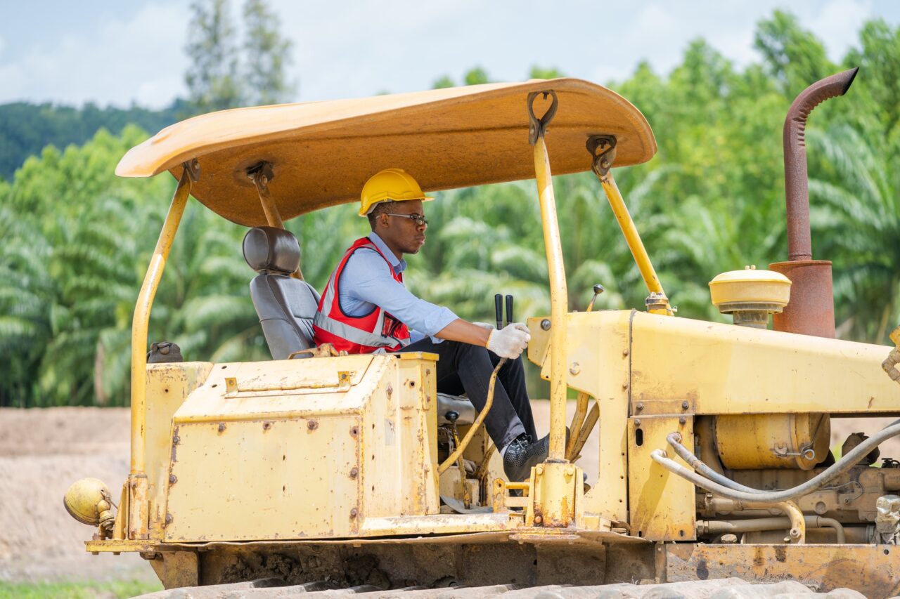 Construction worker are driving bulldozer at construction site.