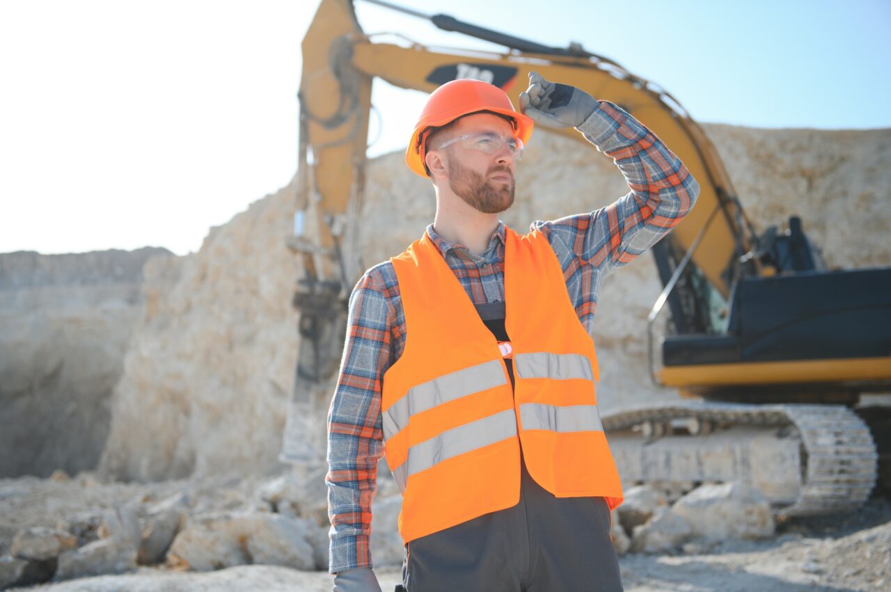Male worker with bulldozer in sand quarry